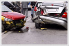 Two severely damaged vehicles after being in a car accident.