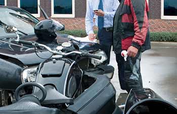 Motorcyclist and driver involved in an accident and calling an experienced RI Motorcycle Accident Lawyer to file a motorcycle accident claim