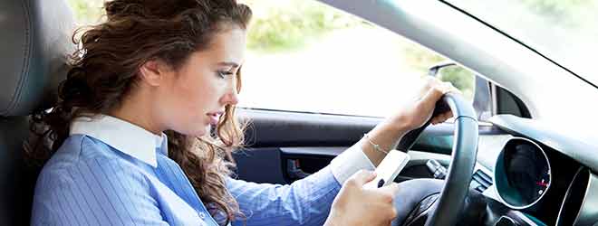 woman driving and texting