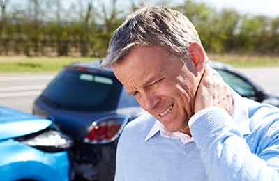 A man touching his neck in pain after a personal injury