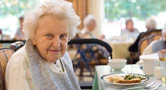 elderly woman eating alone