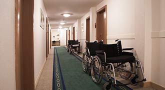 A nursing home hallway with wheelchairs.