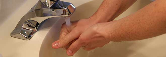 man washing hands to avoid Hospital-Acquired Infections
