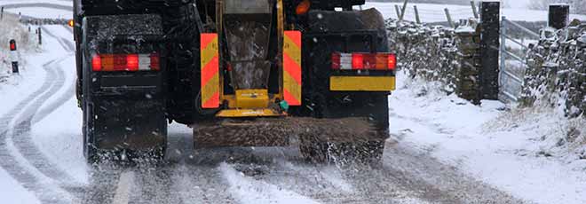 truck salting the icy road