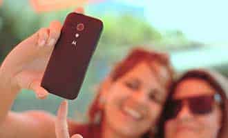 woman taking selfie with friend