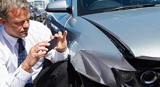 man gathering car accident evidence