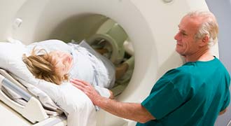 Doctor overseeing CAT scan of patient who had a Misdiagnosis of Cancer