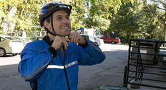 man wearing bicycle helmet to reduce the amount of injury if in a bicycle accident with a car