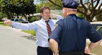 A man doing a sobriety test in front of a cop.