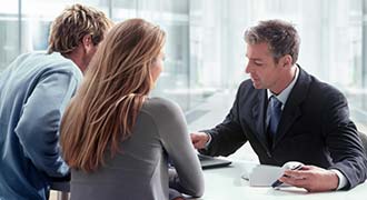 A drunk driving lawyer discussing the case with his clients.