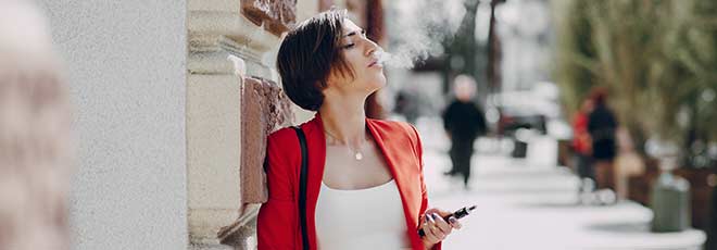 Woman using e-cigarette with failing e-cigarette batteries