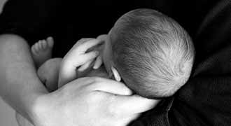 a father holding his new born baby that has a birth defect and needs a RI birth defect lawyer