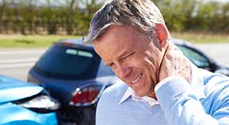 A man touching his neck in pain after a car accident in brockton massachusetts.