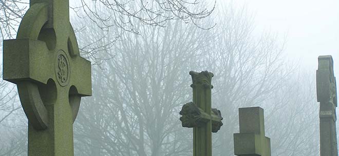 headstones of cemetery in the fog