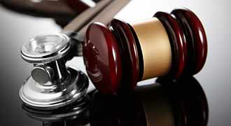 Gavel and stethoscope on a erb's palsy lawyer table.