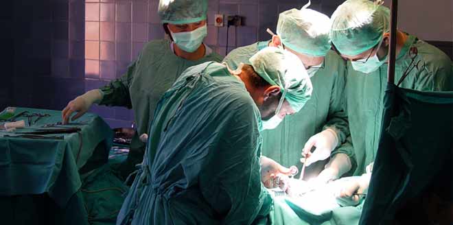 Doctors performing gastric bypass surgery on a patient.