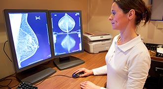 Nurse reviewing breast scan for breast cancer