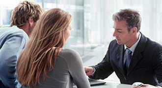 A personal injury lawyer meets with his two clients about their case.