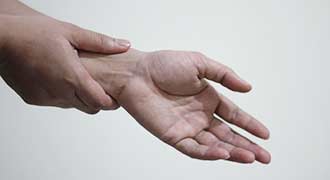 sore hands of a person who has Rheumatoid Arthritis