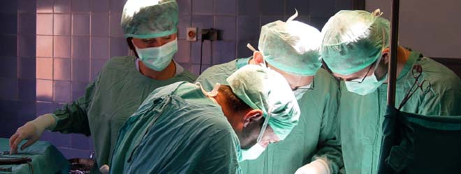 Four surgeons operate on a patient.