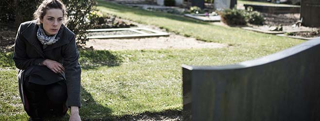 Widow at grave of victim with wrongful death questions