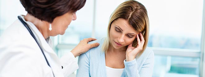 doctor telling woman she is now suffering from fibromyalgia