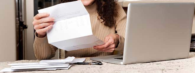 woman looking at Unum Life Insurance Company letter