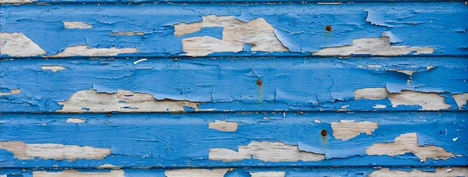 Peeling lead paint on the side of a house is a hazard to children due to lead poisoning