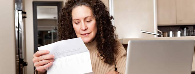 Woman looking over SSDI form before sending to SSA