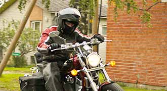 Man following the motorcycle helmet laws as he rides his motorcycle