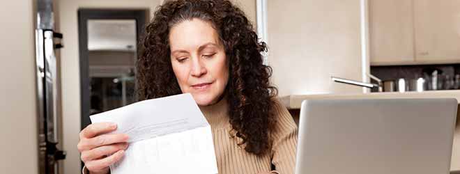 A woman reviewing her medical bills.