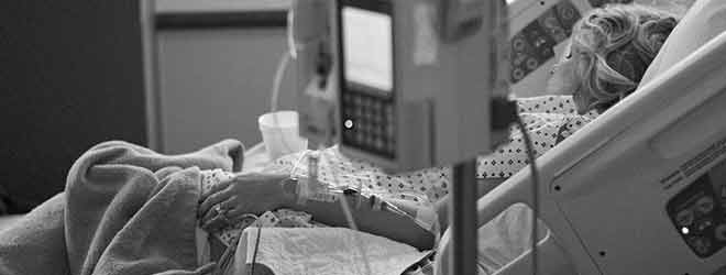 A woman laying in a hospital bed due to a blood disorder seeking social security disability.