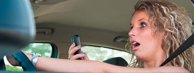 woman about to crash car due to not having her eyes on the road