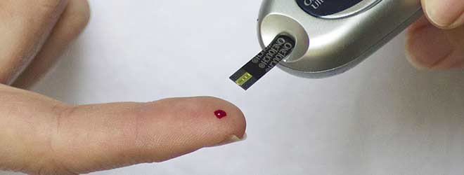 A finger being pricked on the finger of a diabetes patient.