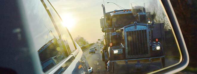 Large Truck seen in car mirror in traffic