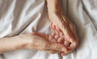 elderly hands with signs of nursing home abuse