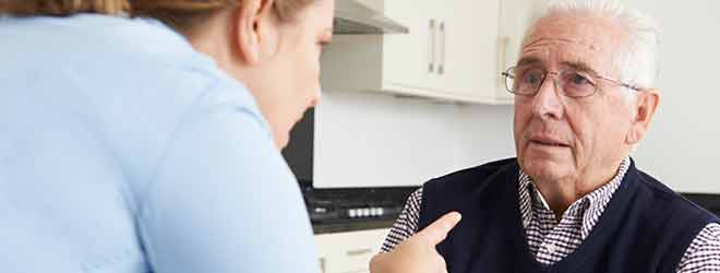 elderly man in nursing home being yelled at by a nurse