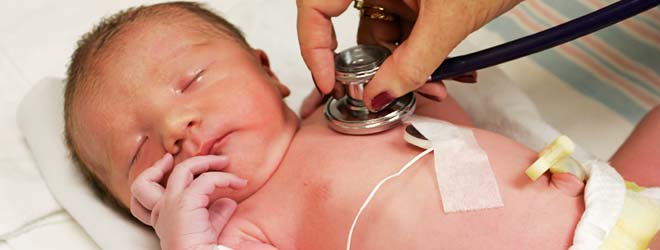 nurse checking on child's birth defects