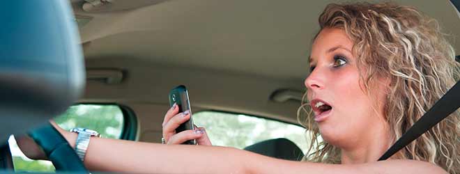 Woman Using A Handheld GPS While Driving