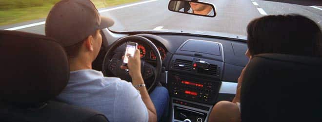 man driving and Reading Text Messages