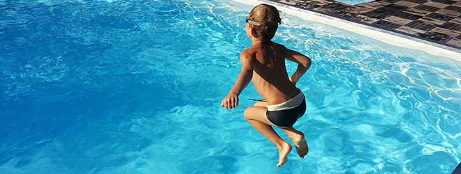 child jumping into Swimming Pool
