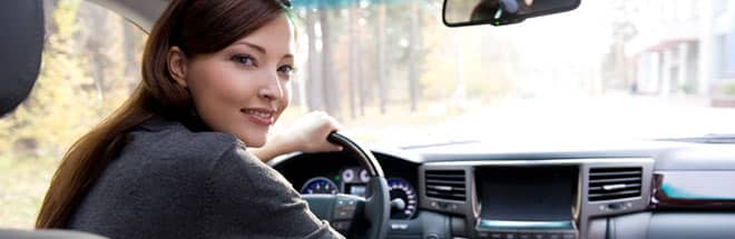 mother looking at backseat of her car for child