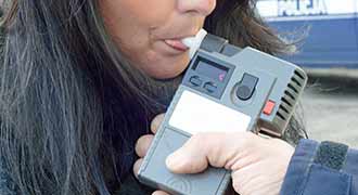 drunk driver being given a breathalyzer test