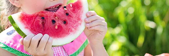 girl eating watermelon during warmer months