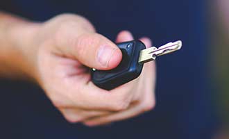 man holding rental car key