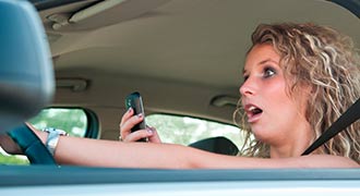 Woman who is Inattentive Driving about to crash her car