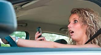 distracted driver using her phone gps