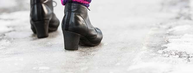 Woman walking on icy walkway