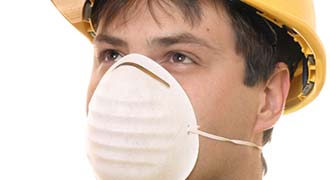 worker wearing mask to prevent inhaling toxic chemicals