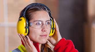woman with ear protection while at a factory